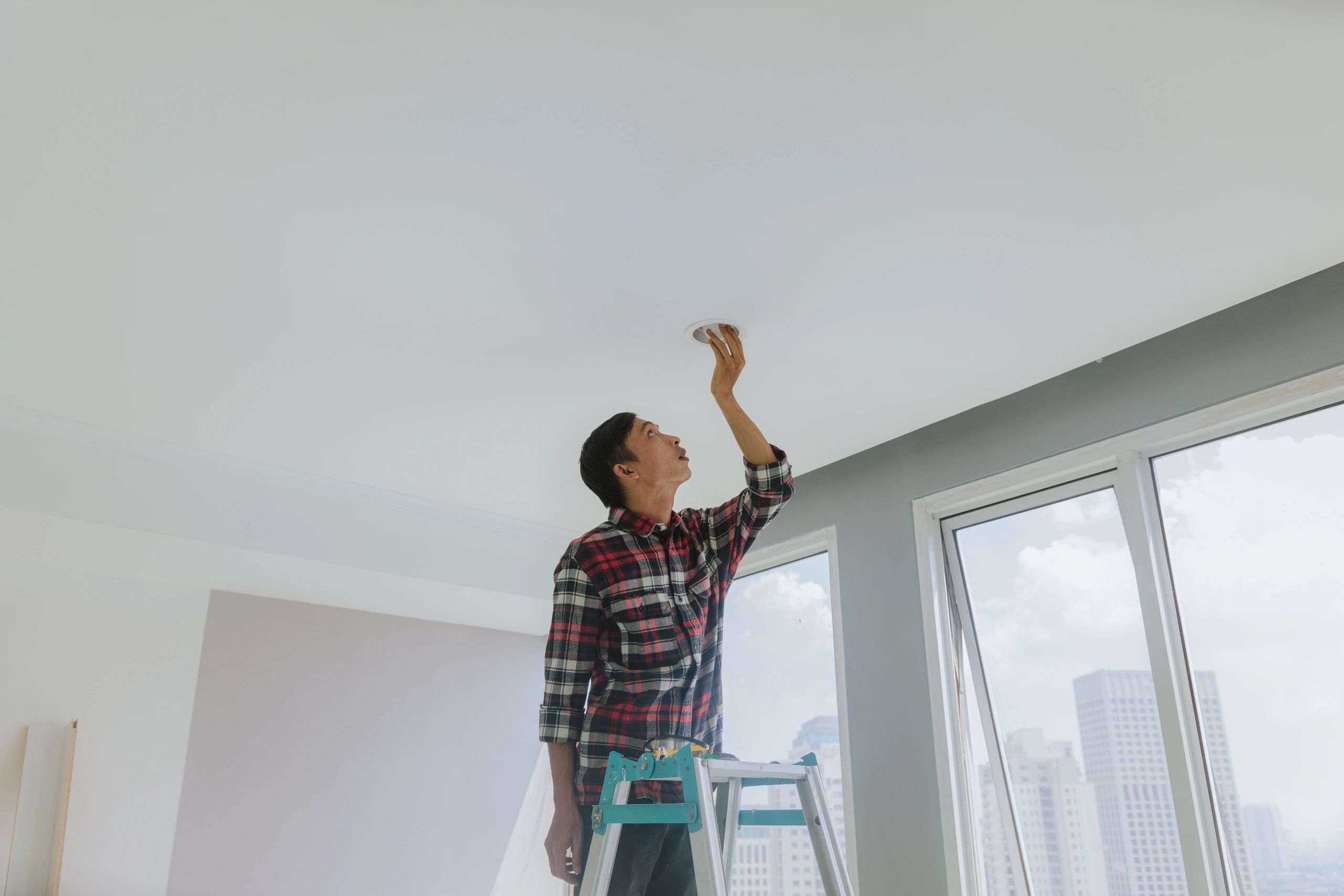 Appliance repair technician performing service work indoors
